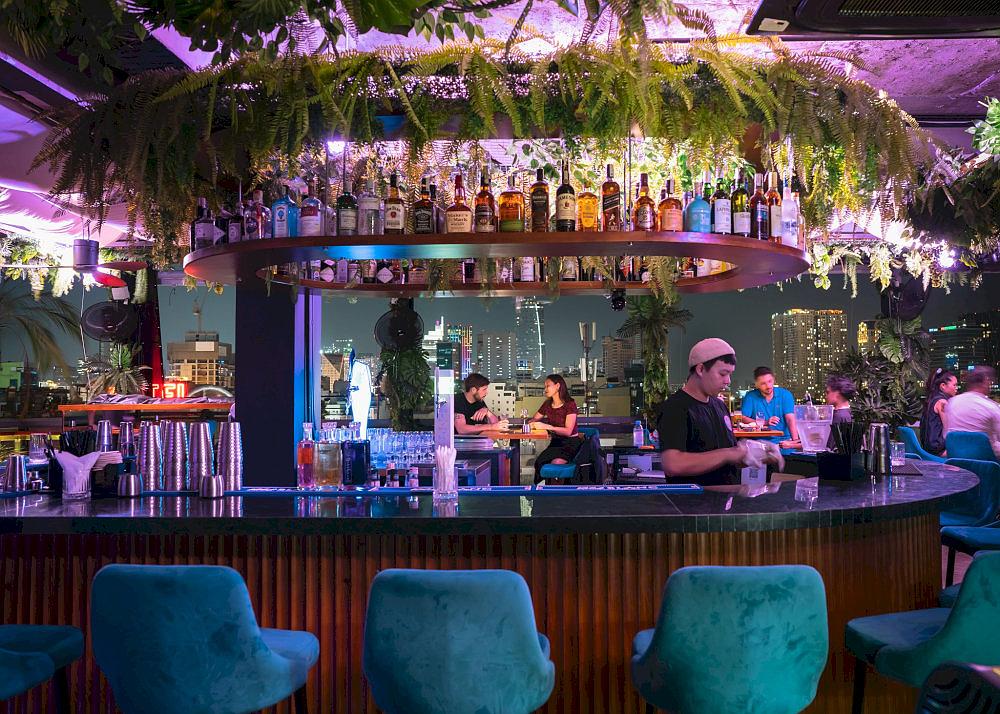 The curved bar is Cocoon’s modern centerpiece, where bartenders perform mixology like an art form